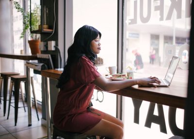 woman in red dress working remotely