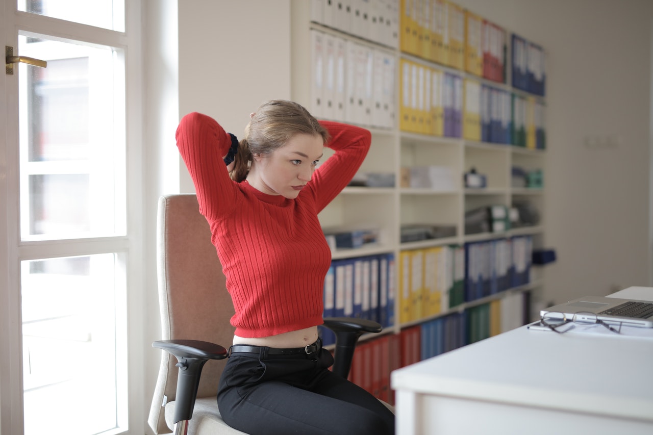 girl doing stretching exercises at the office desk